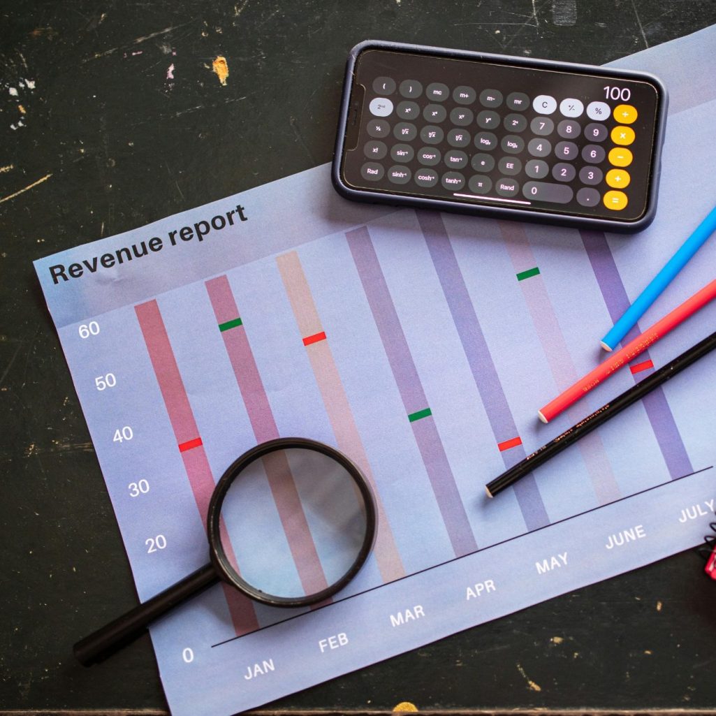 1099 tax forms Calculator and 1099 tax forms on a desk, illustrating year-end contractor reporting for small businesses
